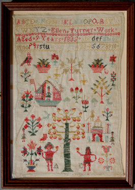 A framed sampler signed Ellen Turner 1835. Elaborately decorated including alphabet, numbers Tree of Knowledge, serpent, Adam and Eve, Noah's Arks, birds, flowers and fruit.