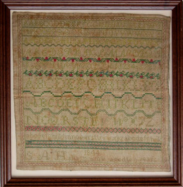 A framed sampler signed S.A. Hallas 1844. Alphabet and numbers repeated. 