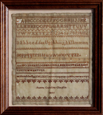 A framed sampler signed Fanny Caroline Chaplin, 1845. Alphabet and lettersm small leaf border at bottom.