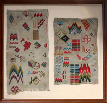 A framed sampler consisting of two pieces of line in one picture frame; with different examples of stitching techniques. Embroiderer unknown.