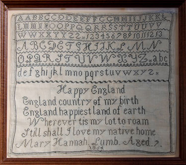A framed sampler signed Mary Hannah Lumb 1864. Alphabet and numbers, poetic verse 'Happy England'.