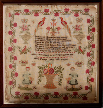 A framed sampler signed Mary Barraclough of West Ardsley near Wakefield, West Yorkshire, 1837. Elaborate design, religious motto, birds butterflies, flowers, two maidens surrounded by flower border.