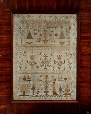 A framed sampler signed Magdalene Lee, 1796. Elaborate design including religous text, female figure in Grecian dress, house, trees, flowers, birds surrounded by honeysuckle border. Linen ground, silk thread, cross stitch, herringbone stitch, satin and al