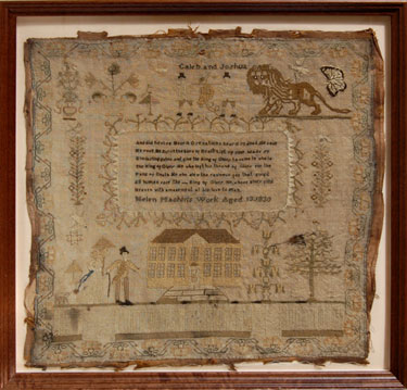 A framed sampler signed Helen Machin 1830. Elaborate design with religious text, Caleb and Joshua as the 'spies of Canaan' carrying a grapevine on a pole, a mansion house, lady with parasol and gentleman with walking stick, tree, flowers, dog, bird, butte