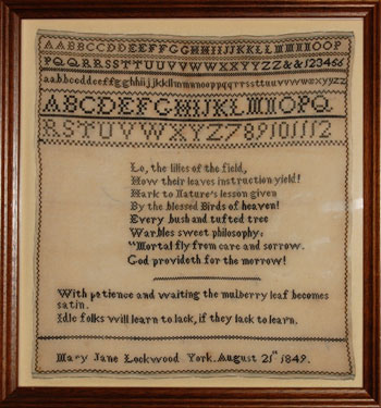 A framed sampler signed Mary Jane Lockwood, York, Yorkshire, 1849. Alphabet, numbers, moral verse.