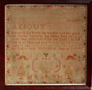 A framed sampler signed Sarah Tolson 1831. Alphabet and numbers, inscription from book of proverbs, flowers, bowl of fruit, dogs, birds, surrounded by floral border.