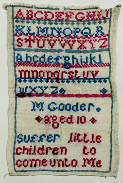 An unframed sampler signed M. Gooder, aged 10. Alphabet and moral verse.