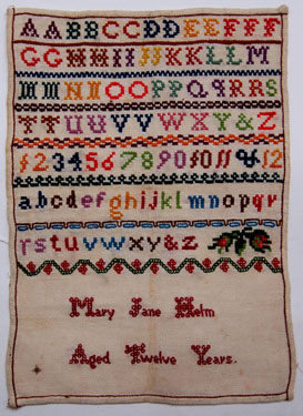 An unframed sampler, signed Mary Jane Helm, aged 12. Alphabet and numbers.