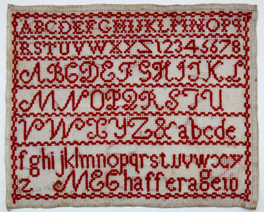 An unframed sampler signed M.E. Chaffer, aged 10; with alphabet and numbers in monochrome red.