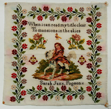 An unframed sampler signed Miss Sarah Jane Pogson between 1840 and 1870. Depicts young girl with a dog; with moral verse, surrounded by floral border.
