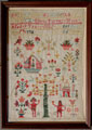 View: ksp00017 A framed sampler signed Ellen Turner 1835. Elaborately decorated including alphabet, numbers Tree of Knowledge, serpent, Adam and Eve, Noah's Arks, birds, flowers and fruit.
