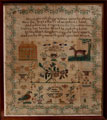 View: ksp00031 A framed sampler signed Hannah Ramsden 1833. Elaborate design, religious text, flowers, birds, cherubs, deer, a house, a tree, border of strawberries.